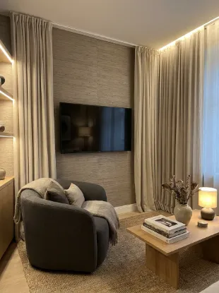 Frame the tv with curtains or wallpaper